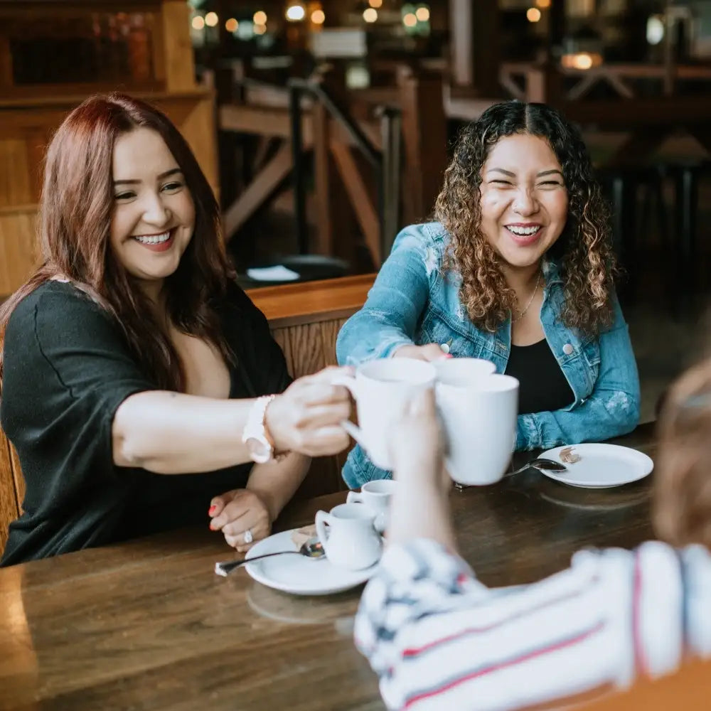group of women cheering cups of coffee